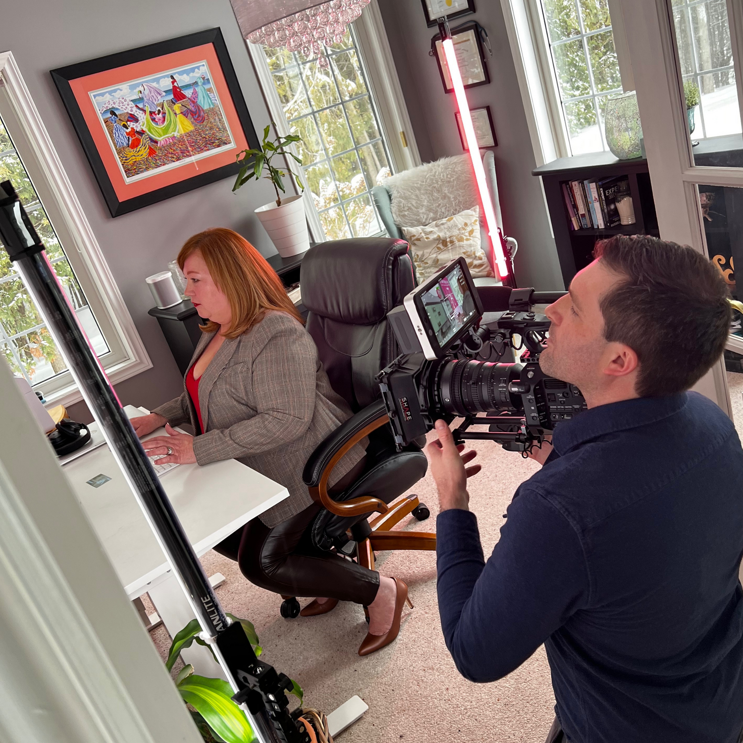 Producer shooting video footage of founder of MamaSoup at work on her social media platform for moms