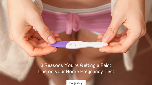 woman in boyshorts holding a pregnancy test with two faint lines