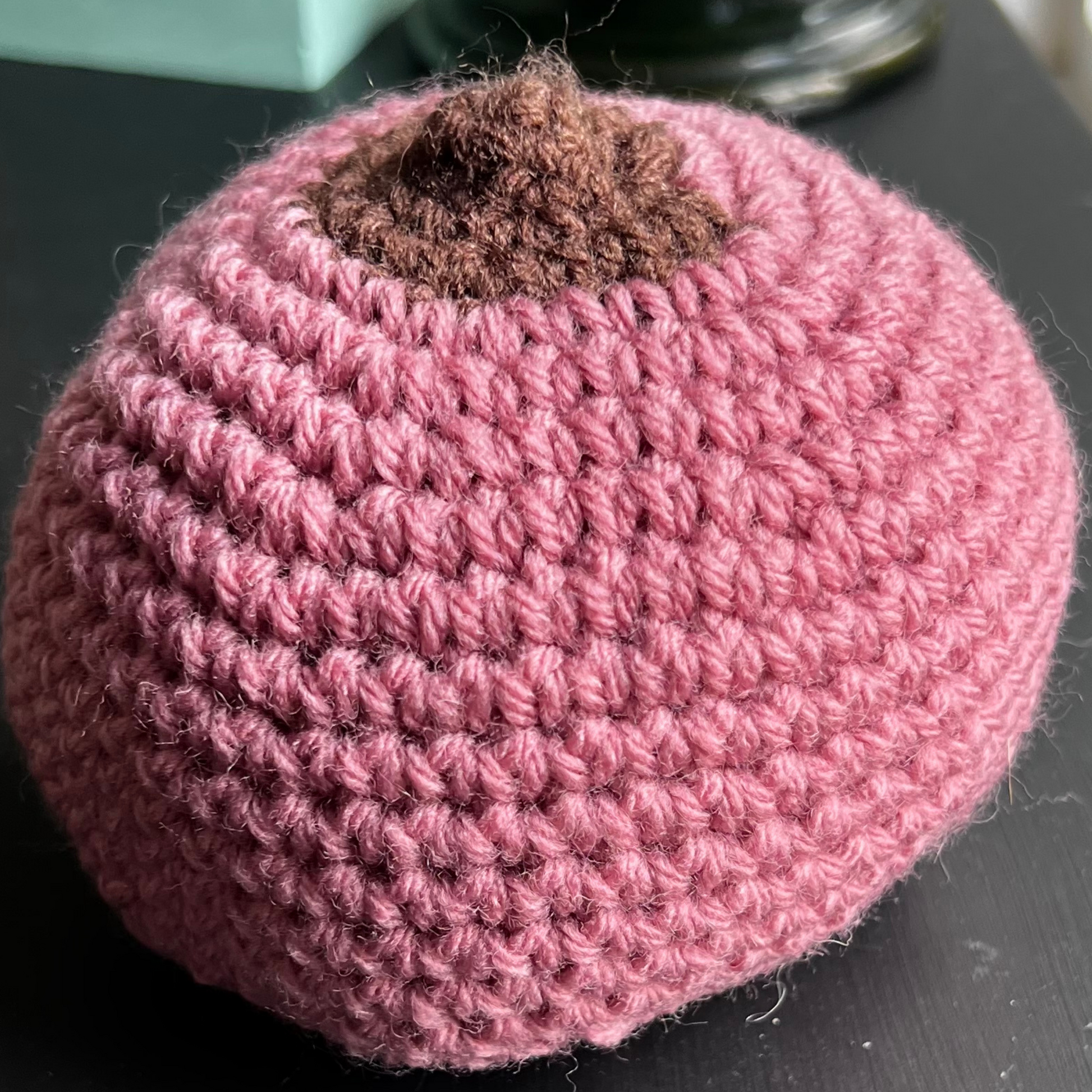 One large rose-coloured crocheted breast model with a flat brown nipple to teach latching a baby for prenatal and breastfeeding educators