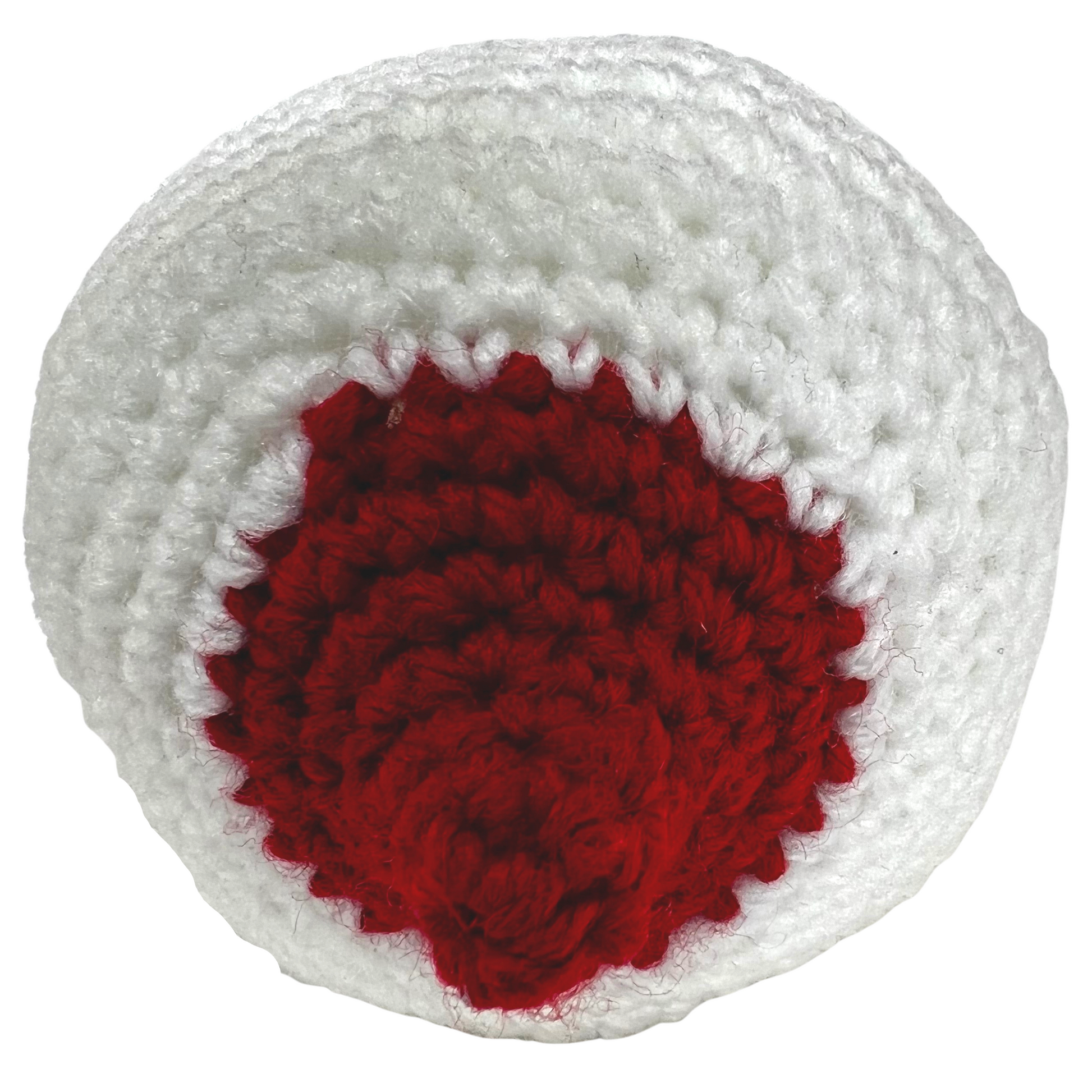 Small white crocheted breast model with a red, perky nipple for breastfeeding education